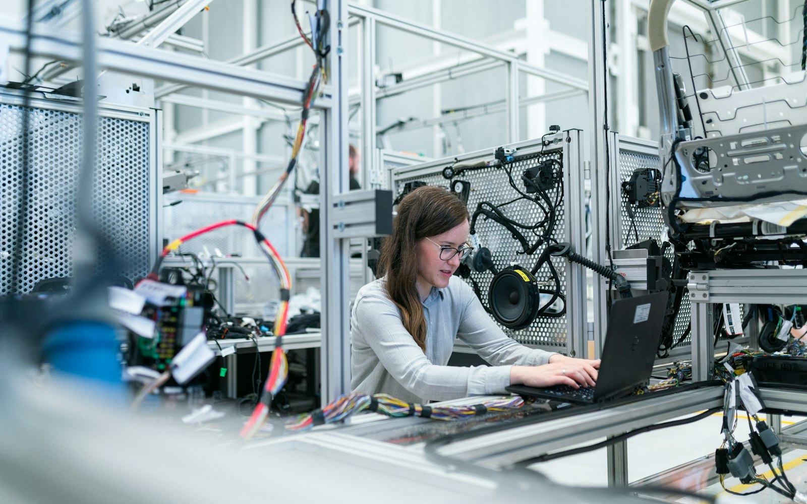 Engineer on a manufacturing floor with production equipment